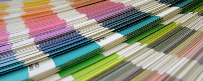An open pantone colour book displaying various colours
